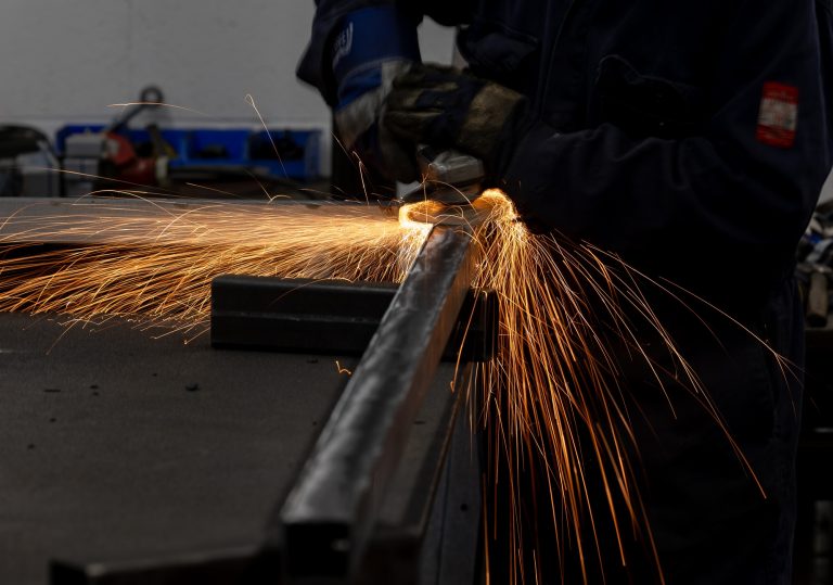 Closeup of a grinder cutting metal, emitting sparks